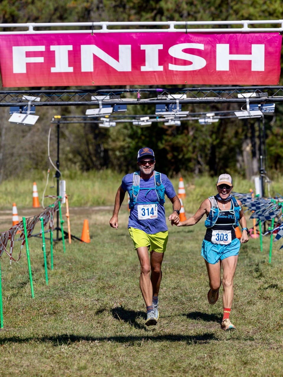 Pic of Mike and Becky crossing the finish line for a marathon.