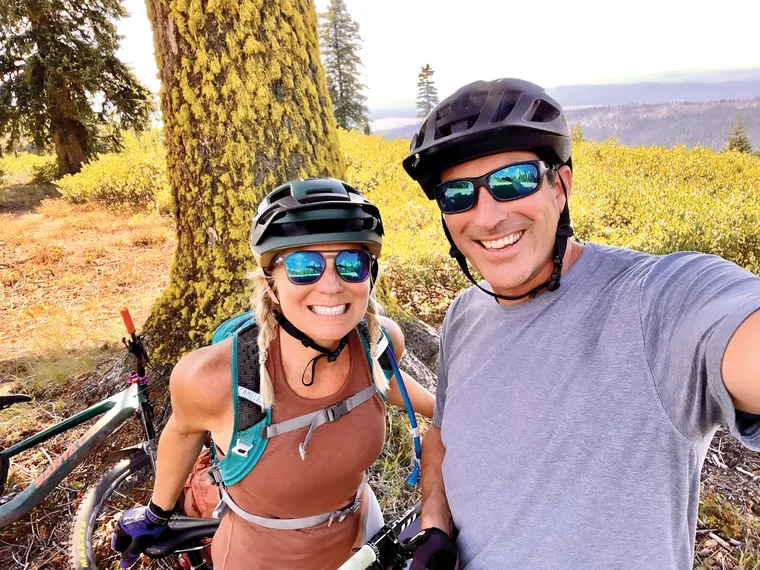 Photo of Alicia and John Roessler on their mountain bikes. 