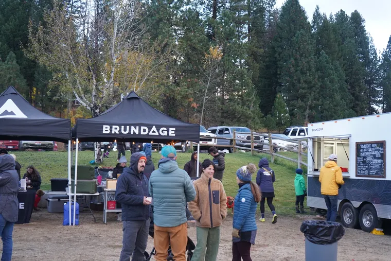 Picture of people talking in front of a beer tent at McCall Life's 2024 Town Edit.